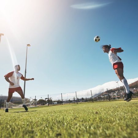 sports team travel and sports tourism - image shows a soccer team playing soccer with setting sun on tour